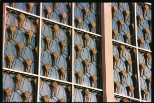 Close-up of decorative gold metalwork on a building window