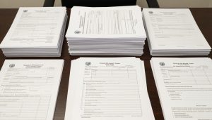 Organized immigration documents and USCIS forms prepared by attorney